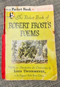 A distressed book cover of Robert Frost's poems.
